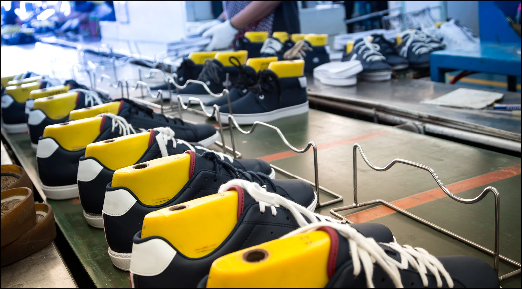 Shoes on a factory production line, illustrating vendor production management.