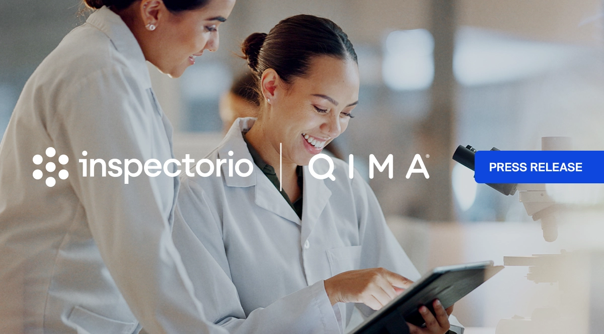 Inspectorio and QIMA press release banner with two lab professionals reviewing a tablet in a laboratory setting.
